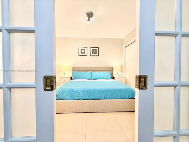 a bedroom with a bed and a night stand