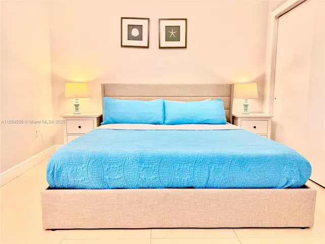 a bedroom with a bed and a night stand