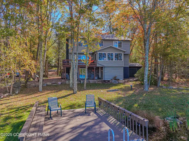 a view of a chairs and table in backyard