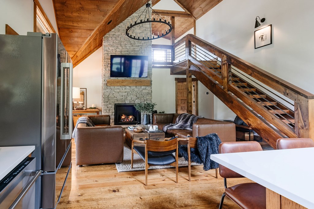 89 High Mdws Drive Morganton, GA 30560 - Photo 20 of 63 a living room with furniture a fireplace and a chandelier