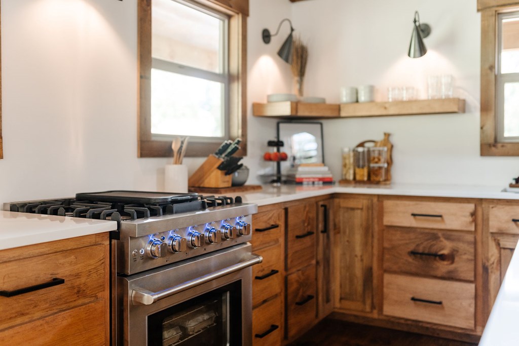 89 High Mdws Drive Morganton, GA 30560 - Photo 24 of 63 a kitchen with stainless steel appliances a stove a sink and a refrigerator