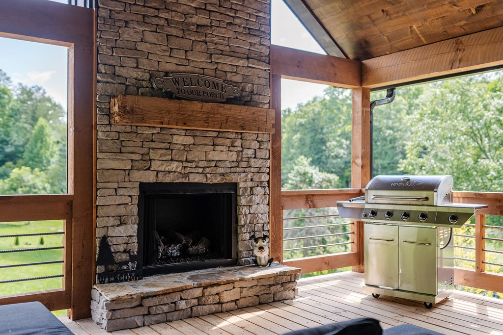 89 High Mdws Drive Morganton, GA 30560 - Photo 35 of 63 a living room with a fireplace and a floor to ceiling window