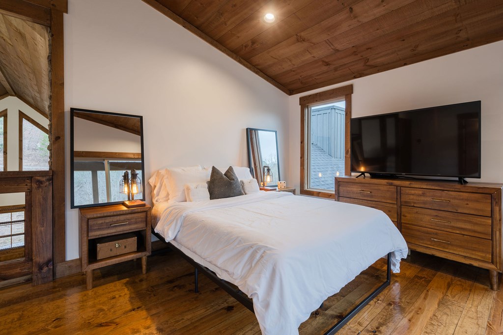 89 High Mdws Drive Morganton, GA 30560 - Photo 52 of 63 a bedroom with a bed and a flat screen tv