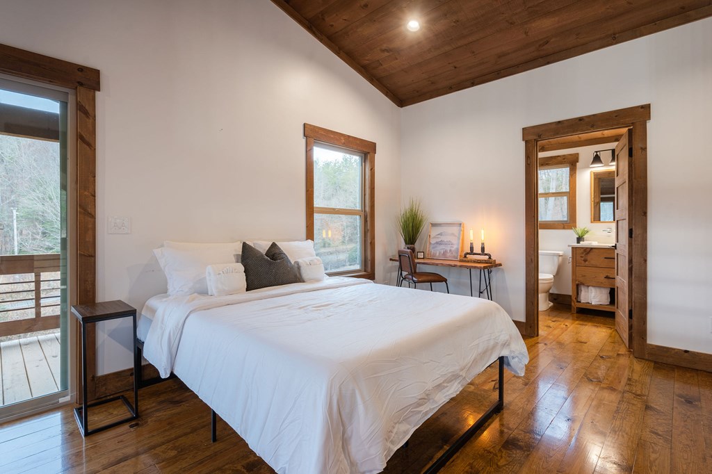 89 High Mdws Drive Morganton, GA 30560 - Photo 55 of 63 a bedroom with a bed and a large mirror on a dresser