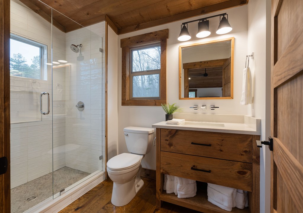 89 High Mdws Drive Morganton, GA 30560 - Photo 57 of 63 a bathroom with a sink mirror toilet and shower