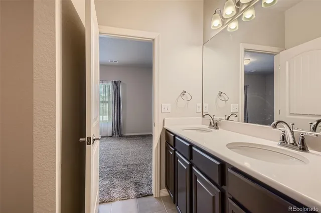 a bathroom with a double vanity sink and a mirror