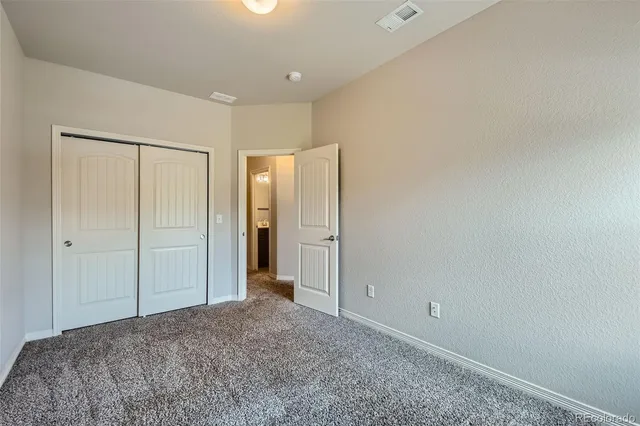 a view of bedroom and hallway