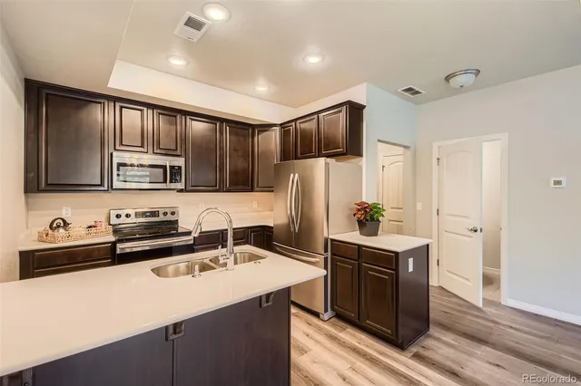 a kitchen that has a sink and a stove in it