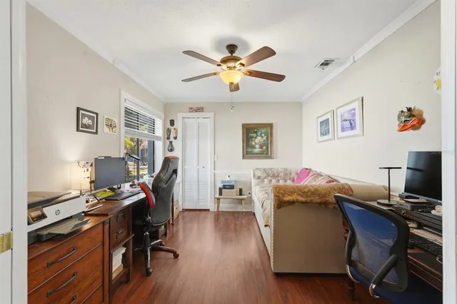 a view of a workspace with furniture and a window