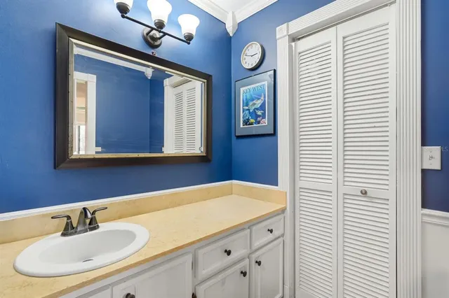 a bathroom with a sink a mirror and a window