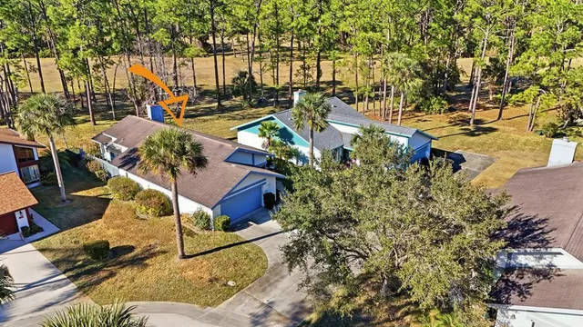 a view of swimming pool with outdoor seating and trees