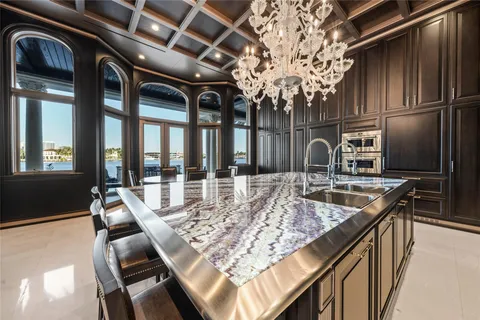 a kitchen with a table chairs and front door