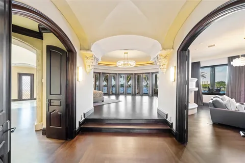 a bedroom with a bed and large windows