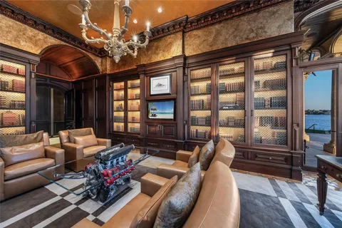 a living room with furniture fireplace and wooden floor