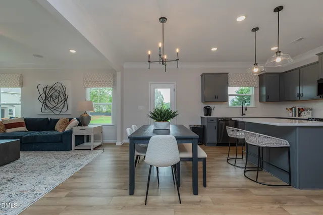 a view of a dining room with furniture window and wooden floor