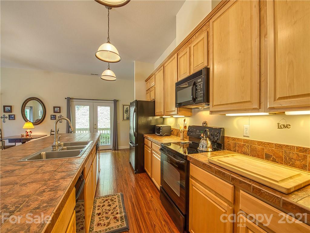 21 Rules Run Road Clyde, NC 28721 - Photo 15 of 32 a kitchen with stainless steel appliances granite countertop a stove a sink and a microwave