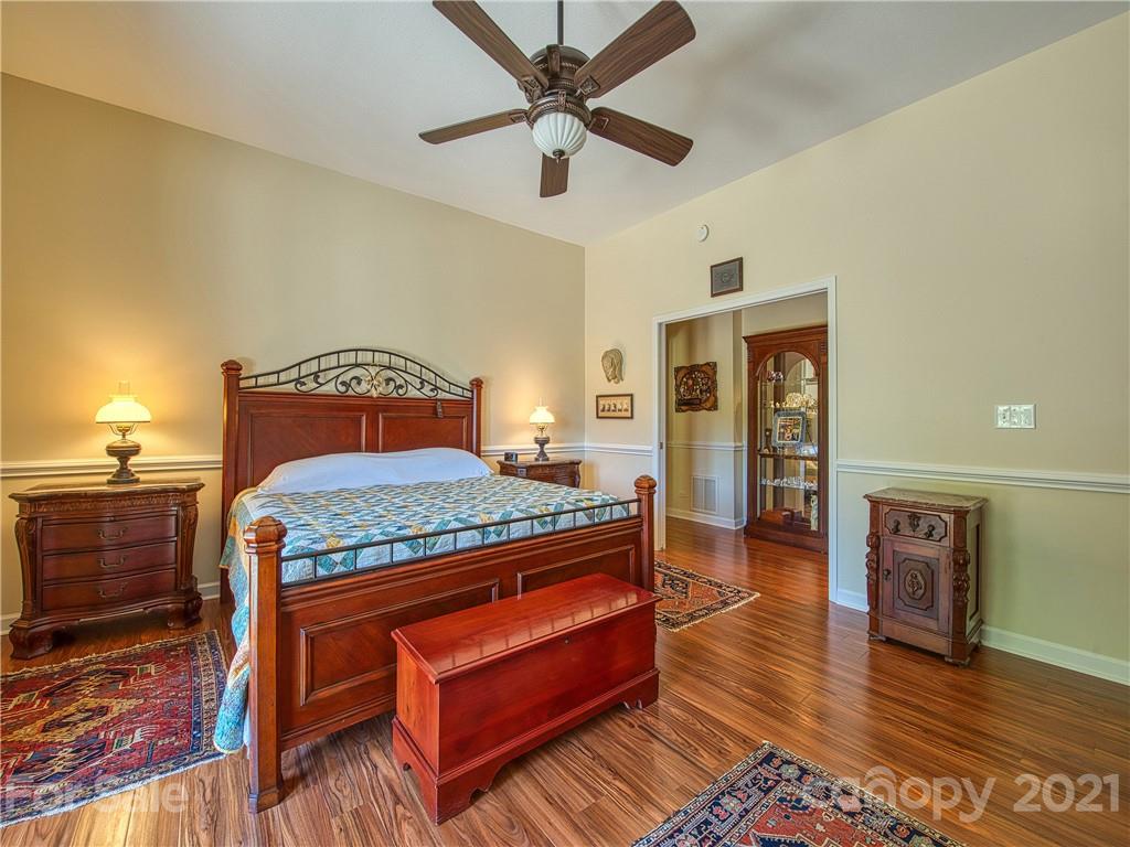21 Rules Run Road Clyde, NC 28721 - Photo 17 of 32 a bedroom with a bed and wooden floor
