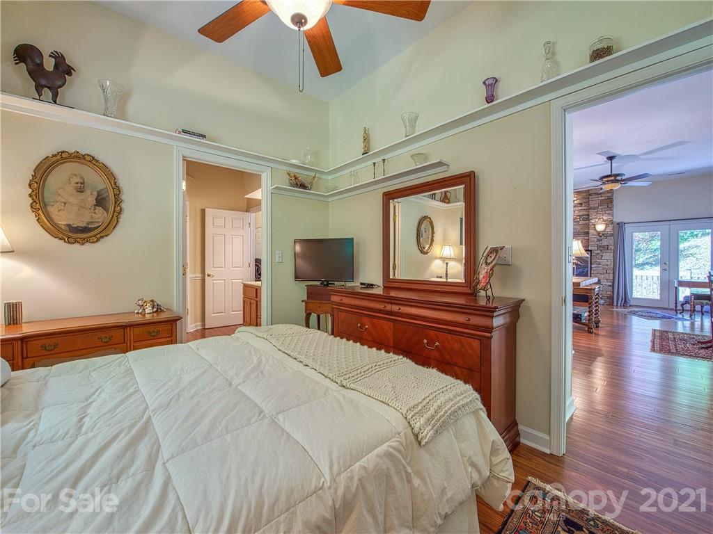21 Rules Run Road Clyde, NC 28721 - Photo 21 of 32 a bedroom with a bed and a chandelier