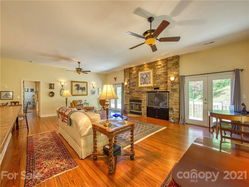 21 Rules Run Road Clyde, NC 28721 - Photo 8 of 32 a living room with fireplace furniture and a wooden floor