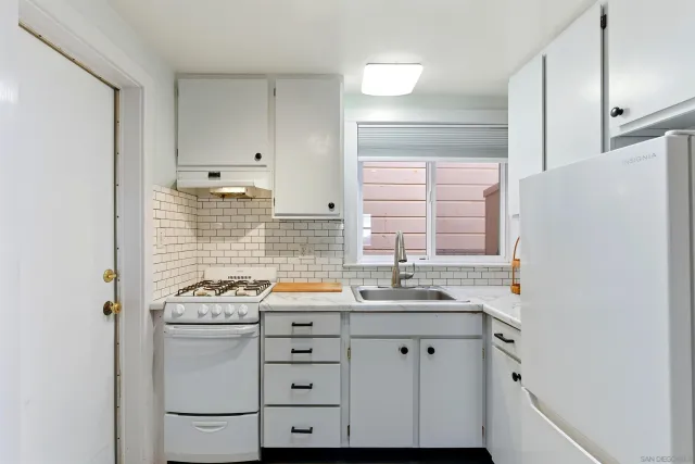 a living room with furniture a rug and a window