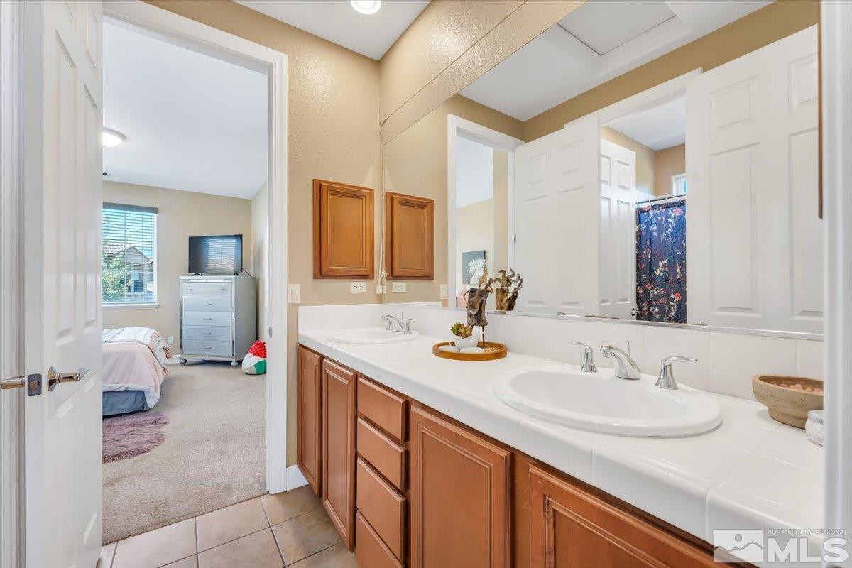 10675 Solano Court Reno, NV 89521 - Photo 20 of 39 a en suite bathroom with a sink and a mirror