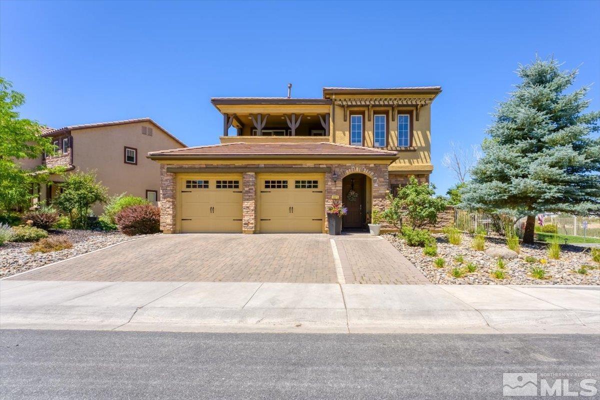 10675 Solano Court Reno, NV 89521 - Photo 2 of 39 a front view of a house with a yard and garage
