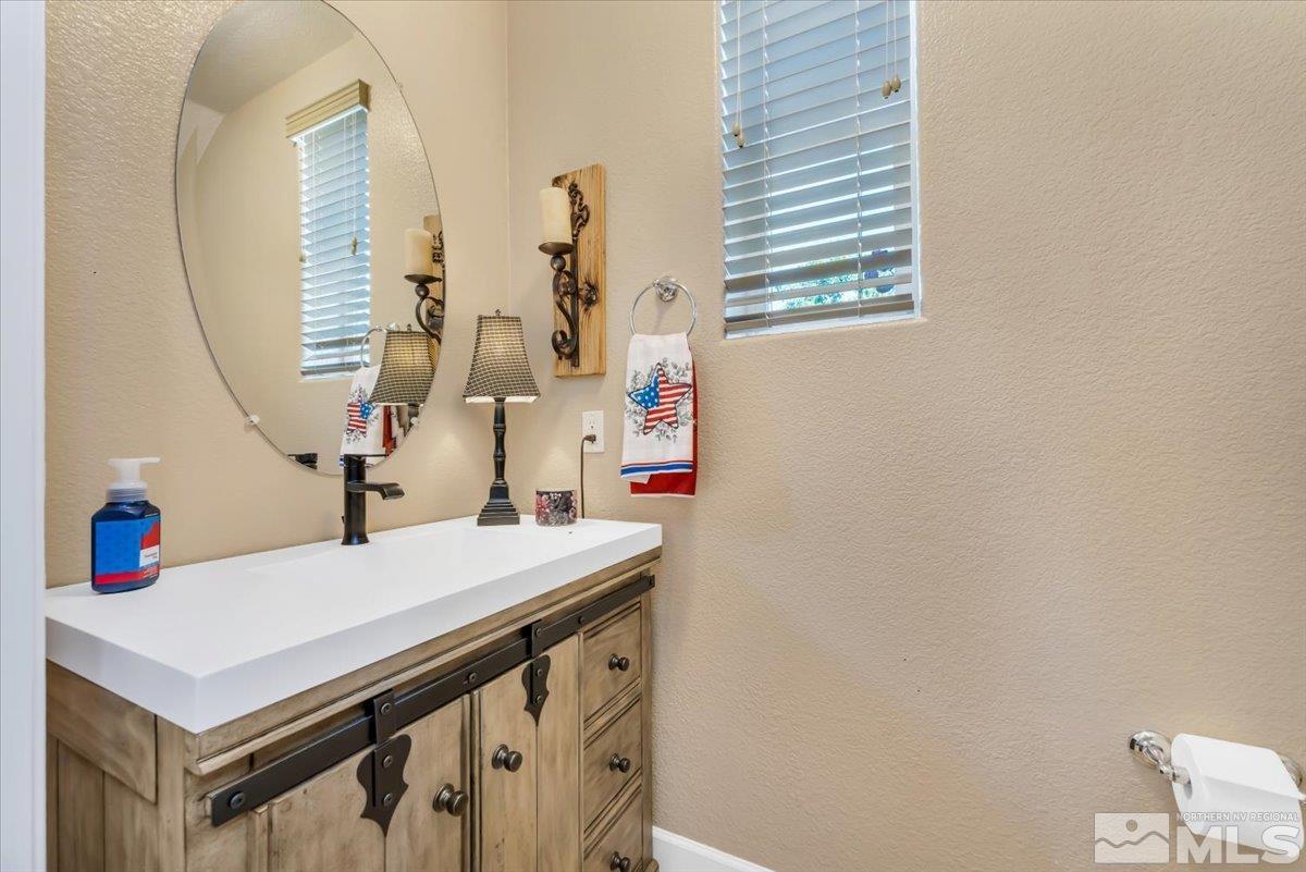 10675 Solano Court Reno, NV 89521 - Photo 27 of 39 a bathroom with a sink vanity and a mirror