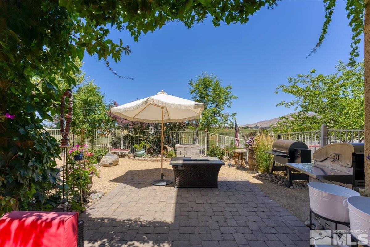 10675 Solano Court Reno, NV 89521 - Photo 29 of 39 an outdoor space with patio lots of furniture and umbrella
