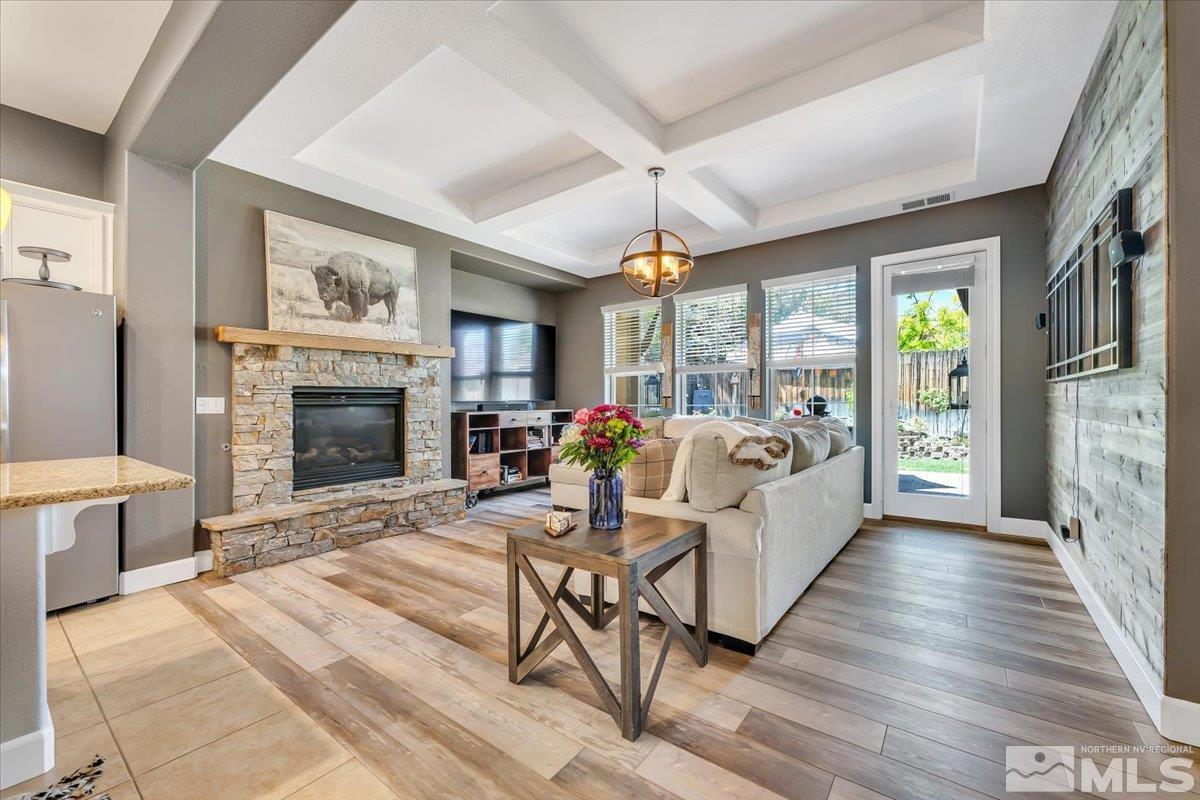 10675 Solano Court Reno, NV 89521 - Photo 8 of 39 a living room with furniture a fireplace and a floor to ceiling window