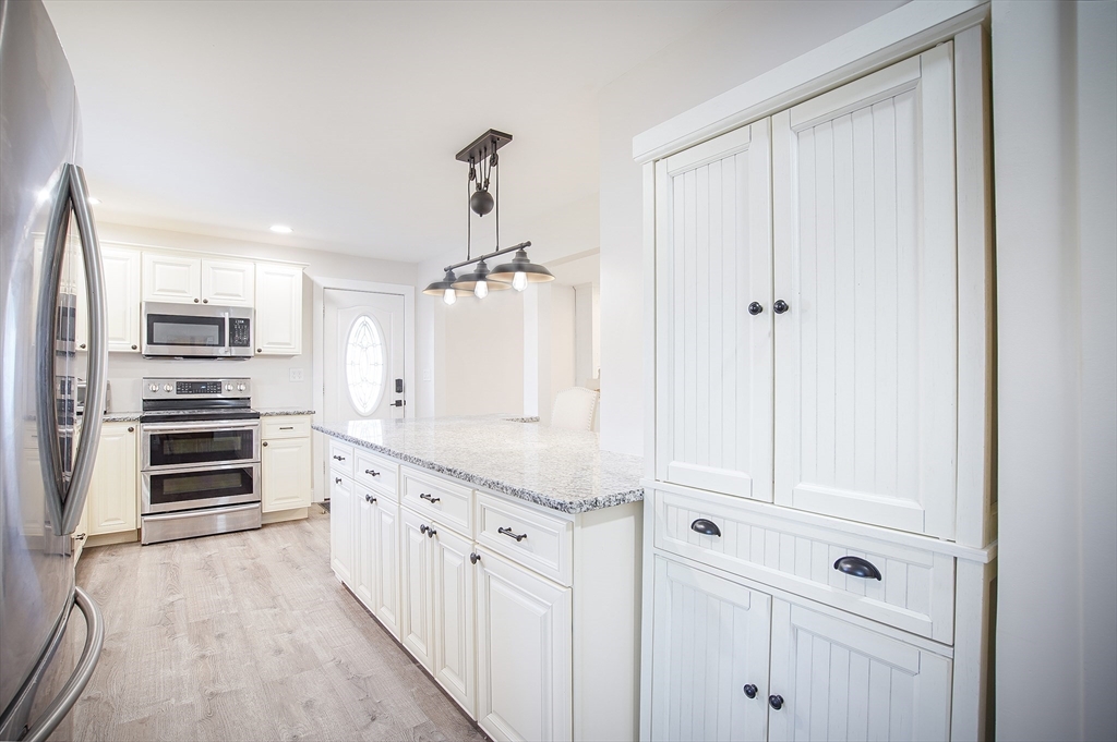 a kitchen with stainless steel appliances a refrigerator and cabinets