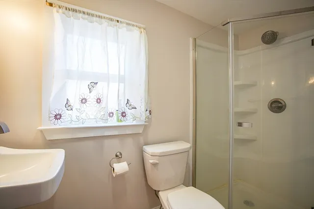 a bathroom with a toilet sink and shower
