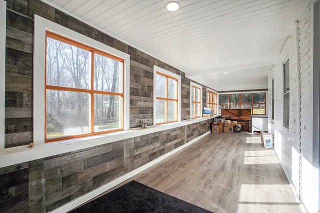 a living room filled with furniture and a large window