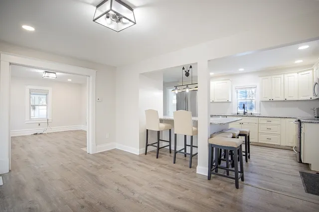 a view of a dining room with furniture and wooden floor