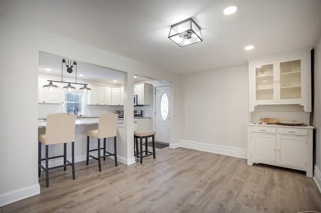 a open kitchen with white cabinets and stainless steel appliances
