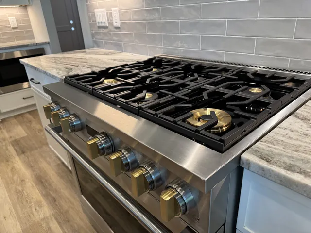 a living room with fireplace furniture and a large window