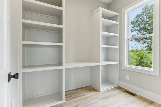 a room with a bed and a window