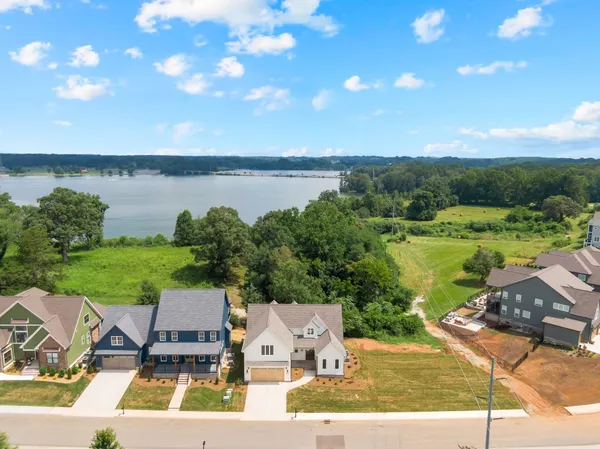 a view of a lake with couches in front of house