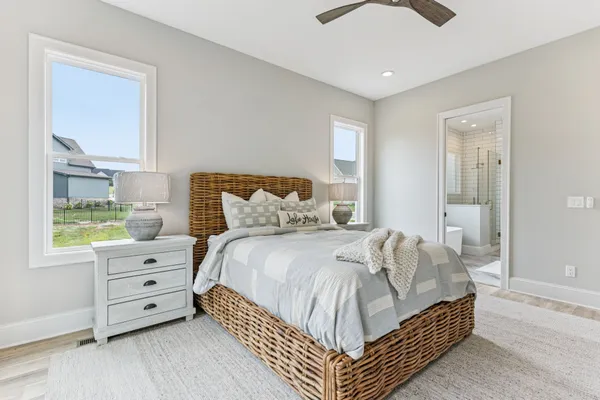 a bedroom with a bed and ceiling fan