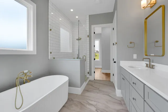 a large bed sitting in a bedroom next to a lamp and window