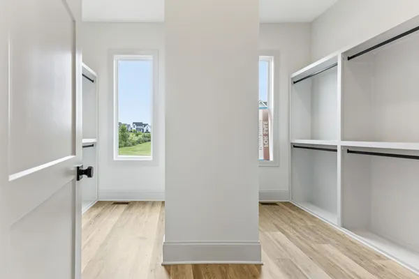 a bedroom with a bed lamp and window