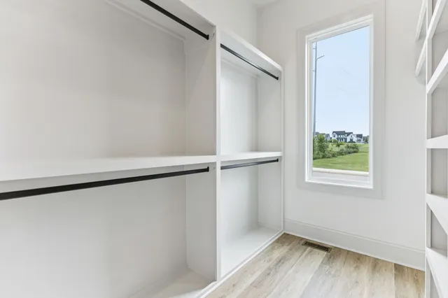 a spacious bedroom with a bed and a ceiling fan