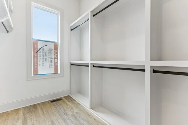 a bedroom with a bed and a mirror