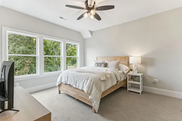 a view of a sign board with large trees