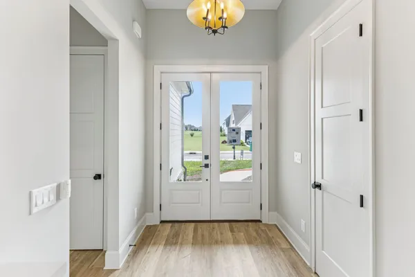 a living room with furniture and a view of kitchen