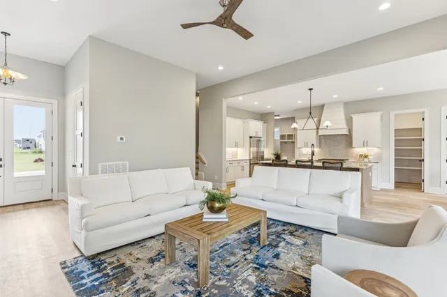 a kitchen with granite countertop a sink and white cabinets