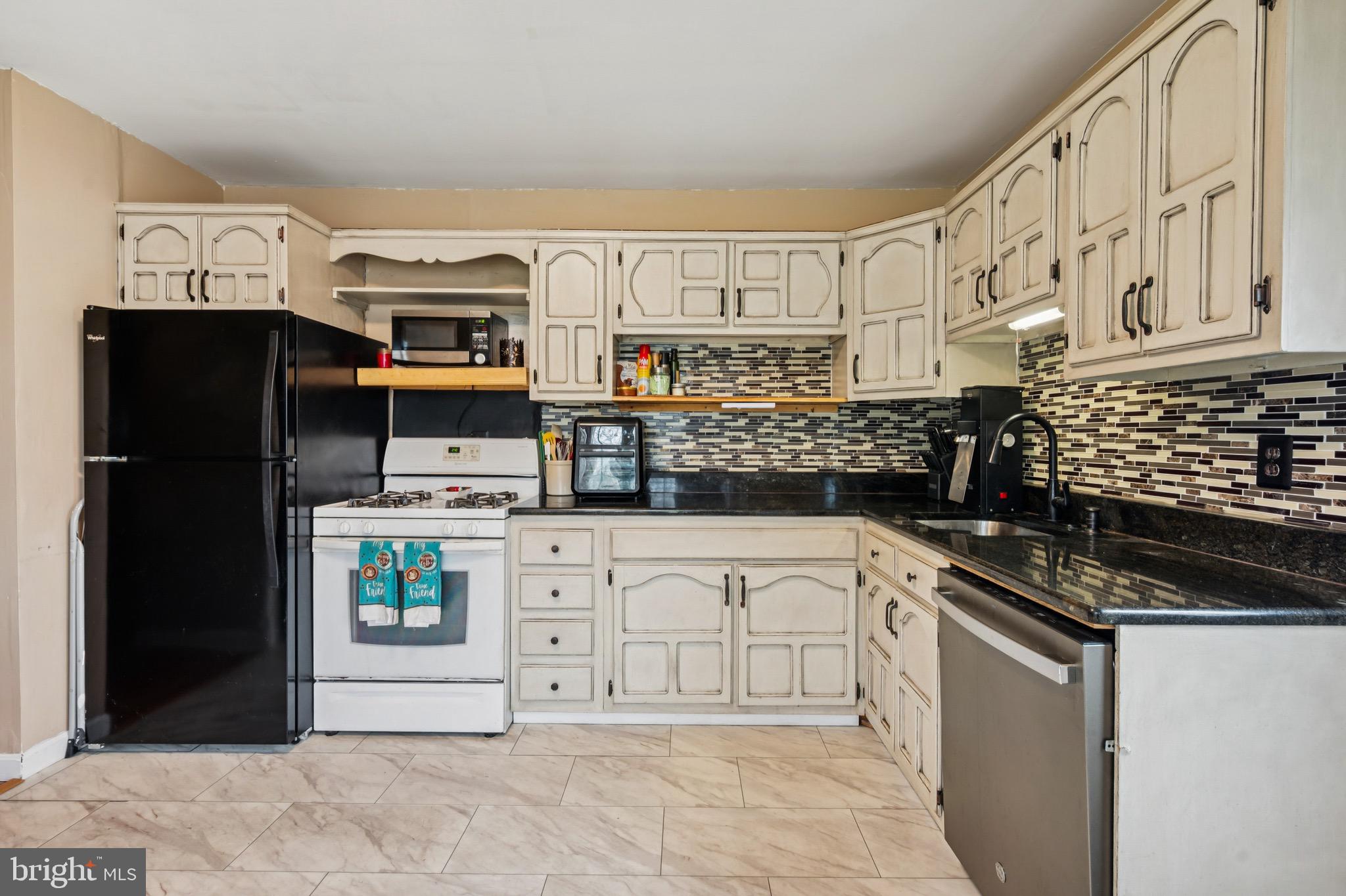 2409 Fries Mill Road Williamstown, NJ 08094 - Photo 11 of 30 a kitchen with stainless steel appliances granite countertop a refrigerator and a stove