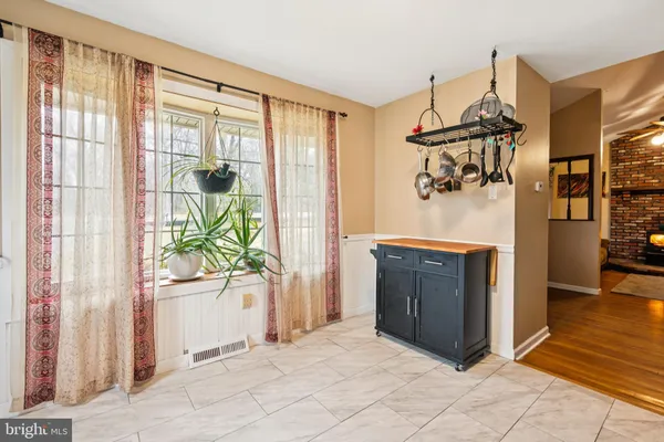 a view of a hallway to a livingroom with furniture wooden floor and windows