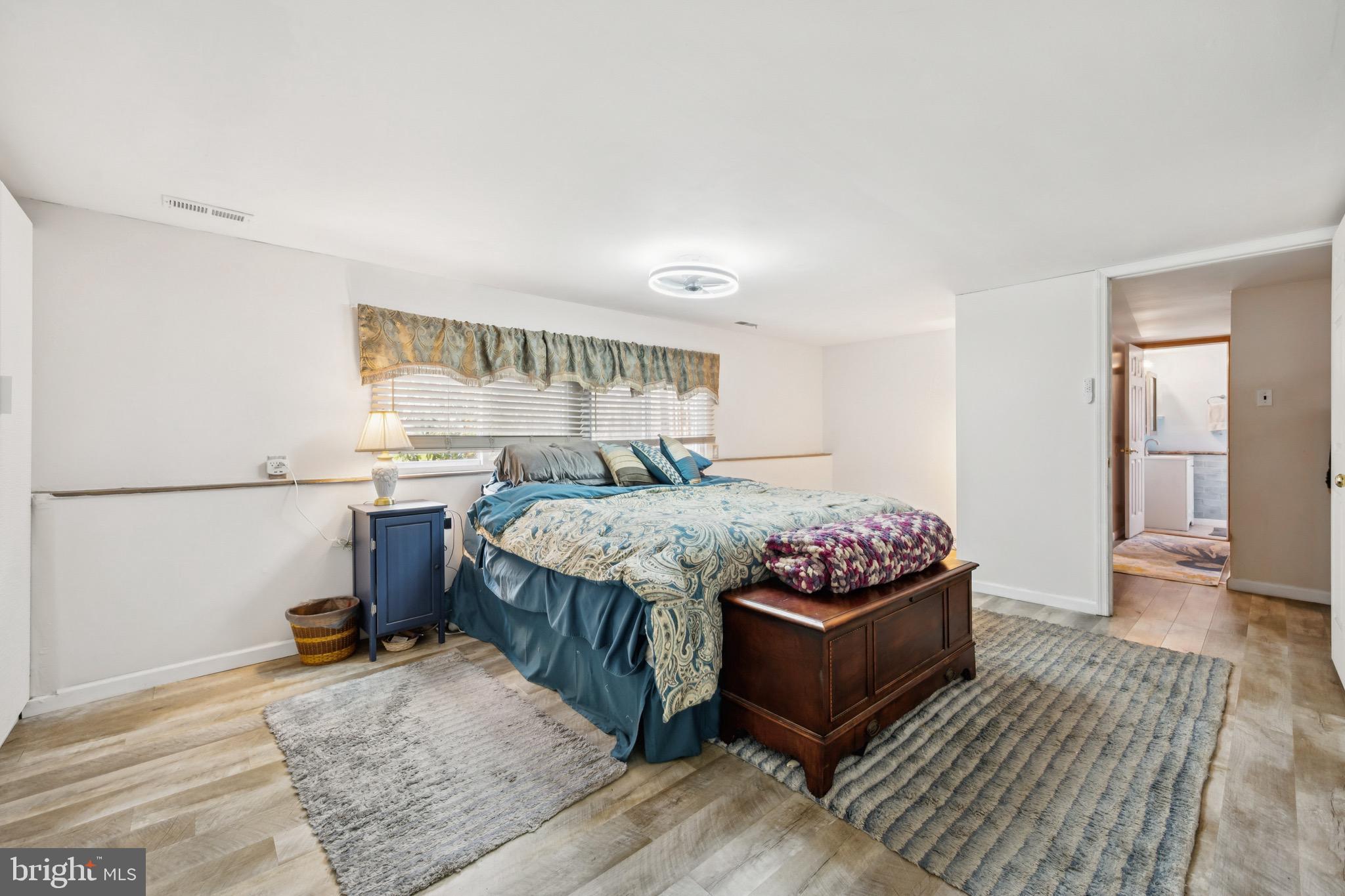 2409 Fries Mill Road Williamstown, NJ 08094 - Photo 15 of 30 a bedroom with a bed and wooden floor