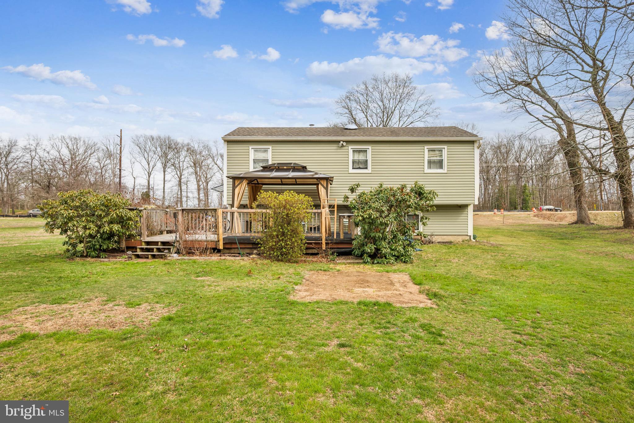 2409 Fries Mill Road Williamstown, NJ 08094 - Photo 25 of 30 a view of a yard in front of a brick house with a large tree