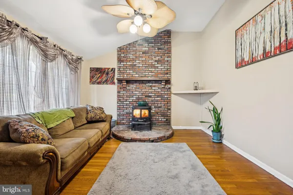 a living room with furniture and a fireplace
